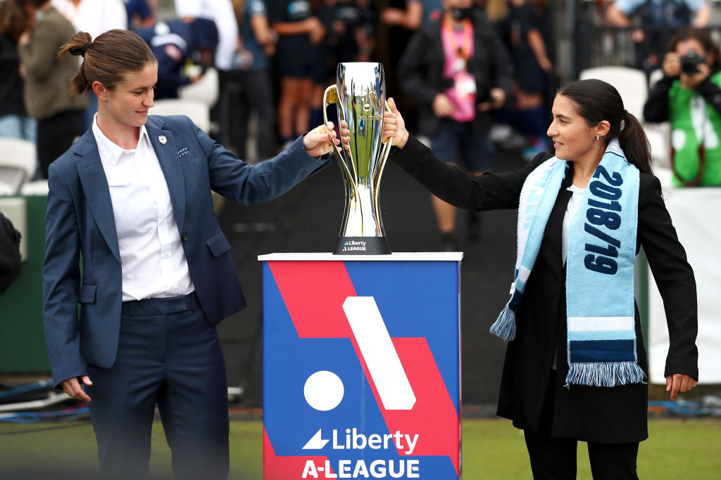 Former Victory player Caitlin Friend and former Sydney FC player Teresa Polias deliver the Liberty A League Champions trophy during the A-League Womens Grand Final match between Sydney FC and Melbourne Victory at Netstrata Jubilee Stadium on March 27, 2022, in Sydney, Australia. (Photo by Mark Metcalfe/Getty Images)