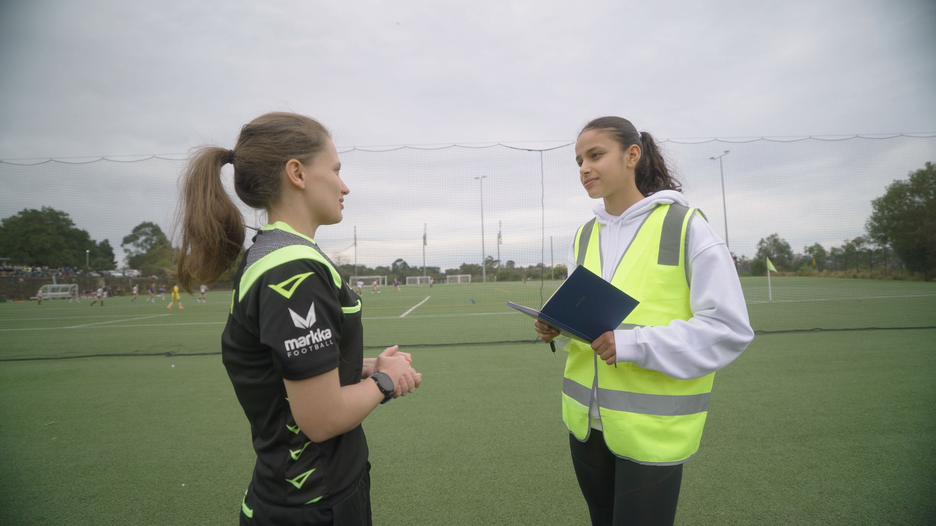 Talia Younis in conversation with referee Chloe Gray